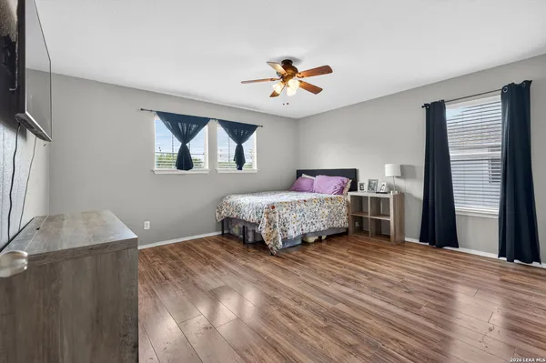 a bedroom with a bed chandelier and a window