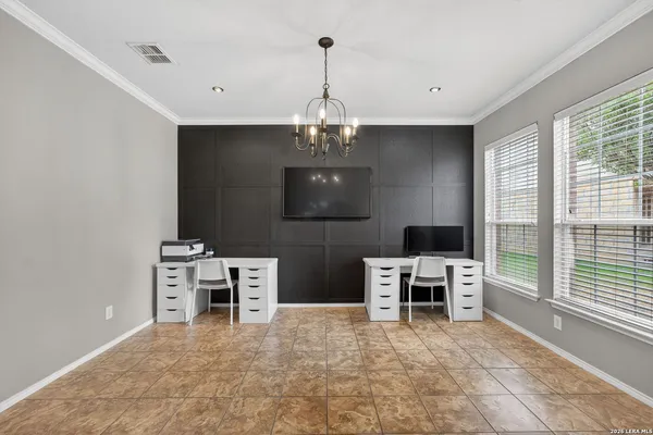 a view of a workspace with furniture and a window