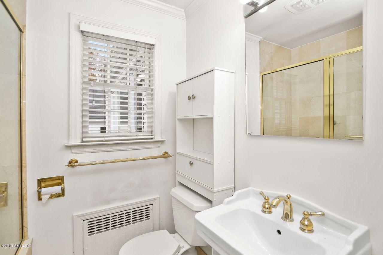 87 Lockwood Road Riverside, CT 06878 - Photo 26 of 29 a bathroom with a sink a toilet and shower