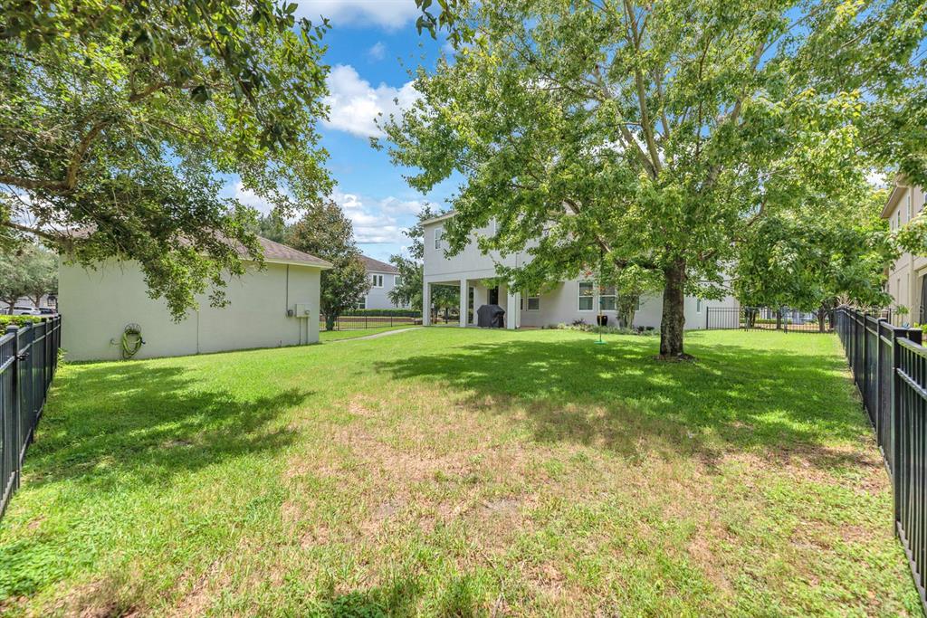 5310 Fishhawk Ridge Drive Lithia, FL 33547 - Photo 45 of 52 a view of a white house with a big yard and large trees