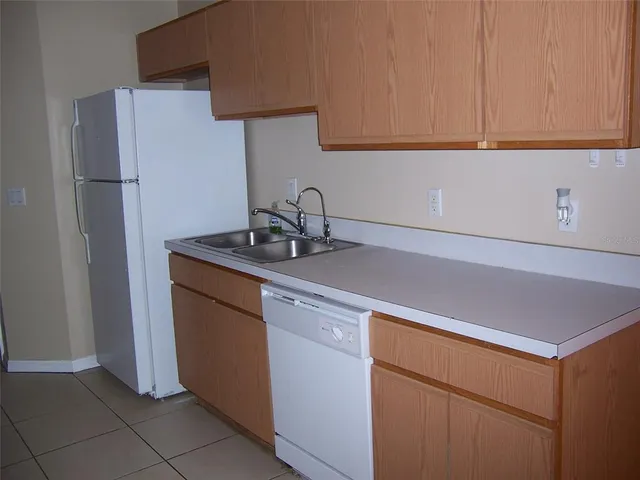 a kitchen with a sink and a refrigerator