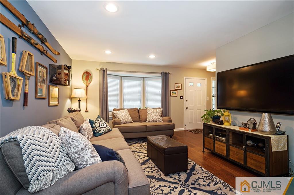 2406 Timber Oaks Road, Unit 2406 Edison, NJ 08820 - Photo 11 of 24 a living room with furniture and a flat screen tv
