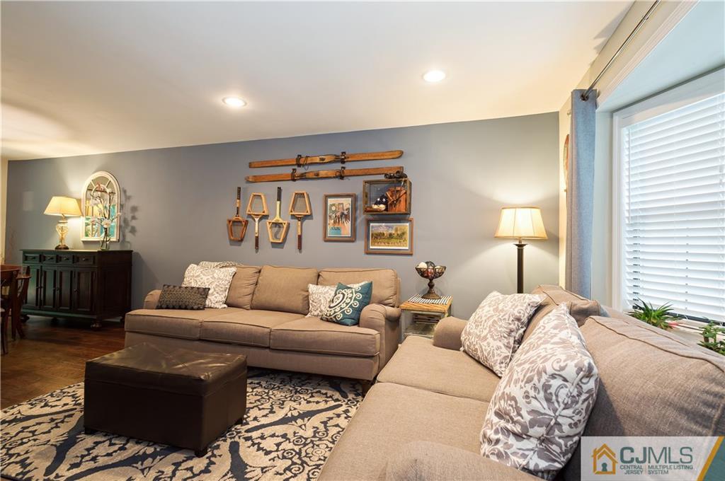 2406 Timber Oaks Road, Unit 2406 Edison, NJ 08820 - Photo 13 of 24 a living room with furniture and a lamp