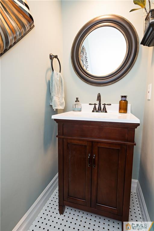 2406 Timber Oaks Road, Unit 2406 Edison, NJ 08820 - Photo 14 of 24 a bathroom with a sink a toilet and a mirror