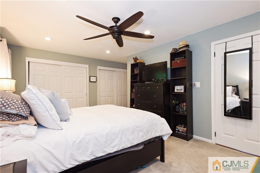 2406 Timber Oaks Road, Unit 2406 Edison, NJ 08820 - Photo 16 of 24 a bedroom with a bed and a flat screen tv