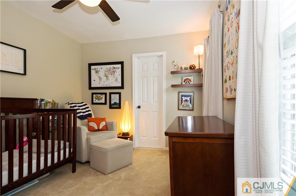 2406 Timber Oaks Road, Unit 2406 Edison, NJ 08820 - Photo 21 of 24 a living room with furniture and a flat screen tv