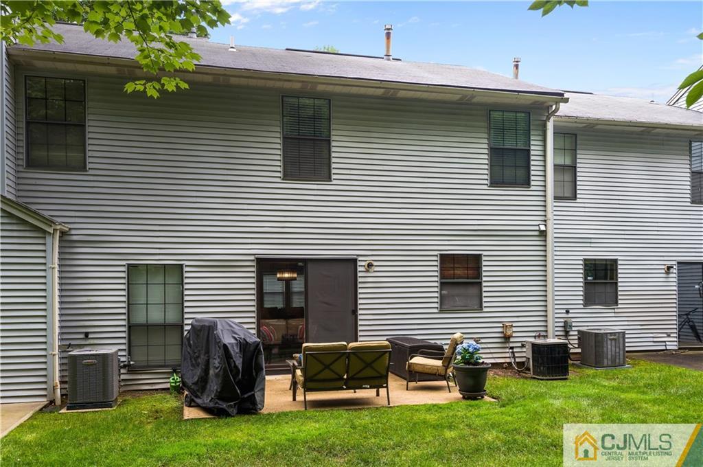 2406 Timber Oaks Road, Unit 2406 Edison, NJ 08820 - Photo 23 of 24 a front view of house with yard and outdoor seating