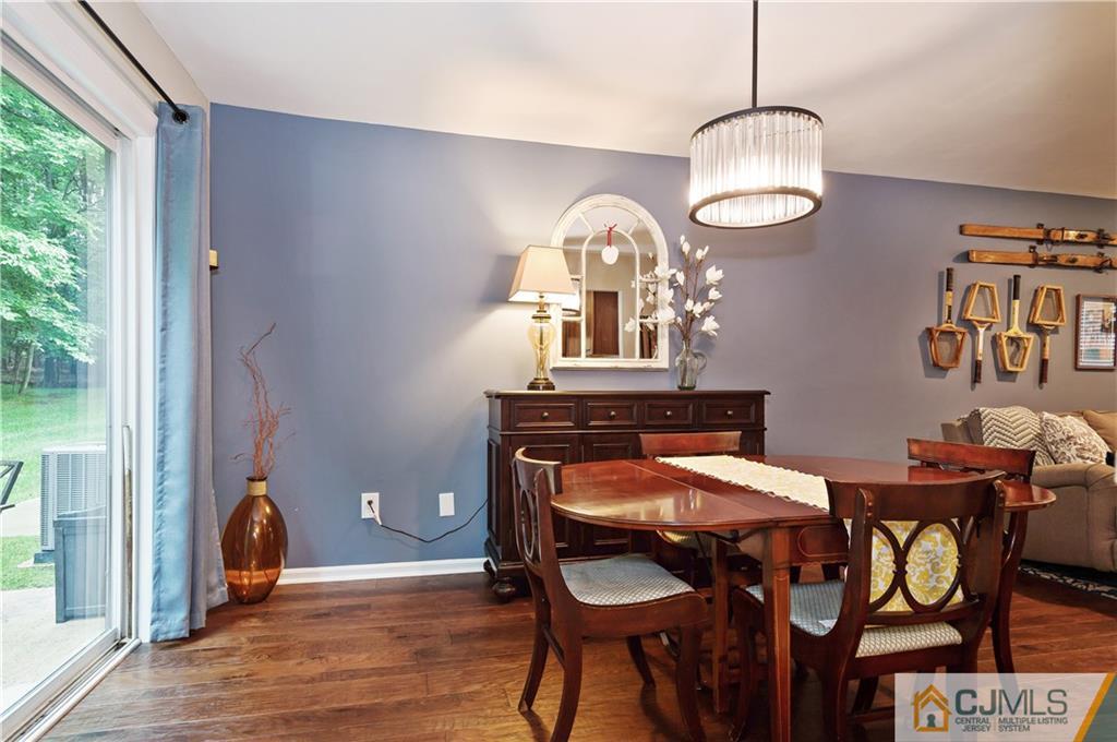 2406 Timber Oaks Road, Unit 2406 Edison, NJ 08820 - Photo 8 of 24 a view of a dining room with furniture window and wooden floor