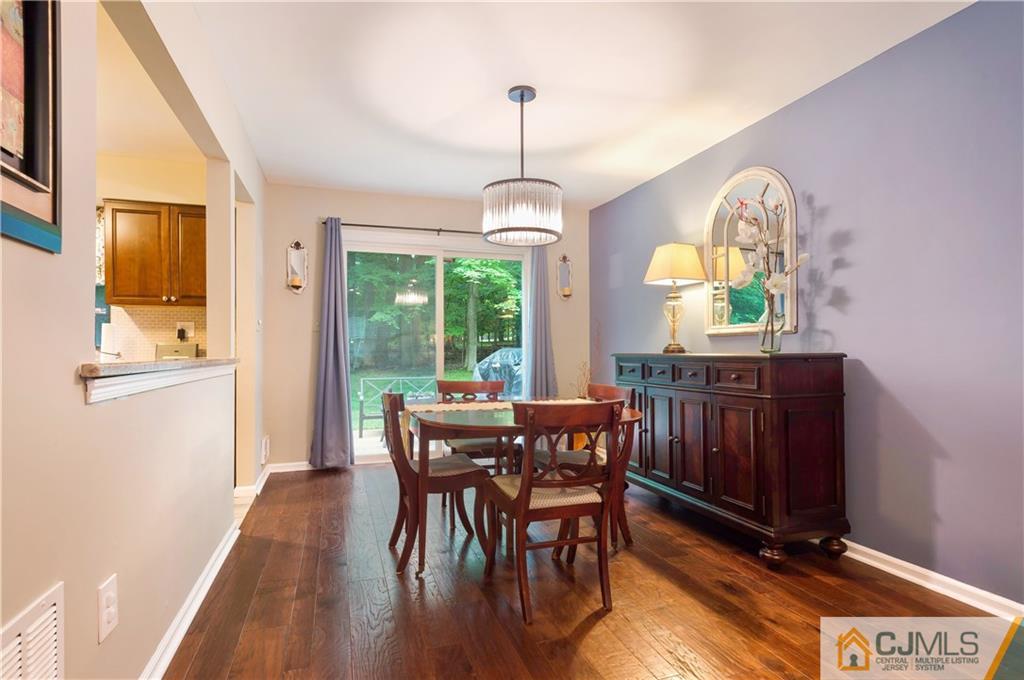 2406 Timber Oaks Road, Unit 2406 Edison, NJ 08820 - Photo 9 of 24 a view of a dining room with furniture window and wooden floor