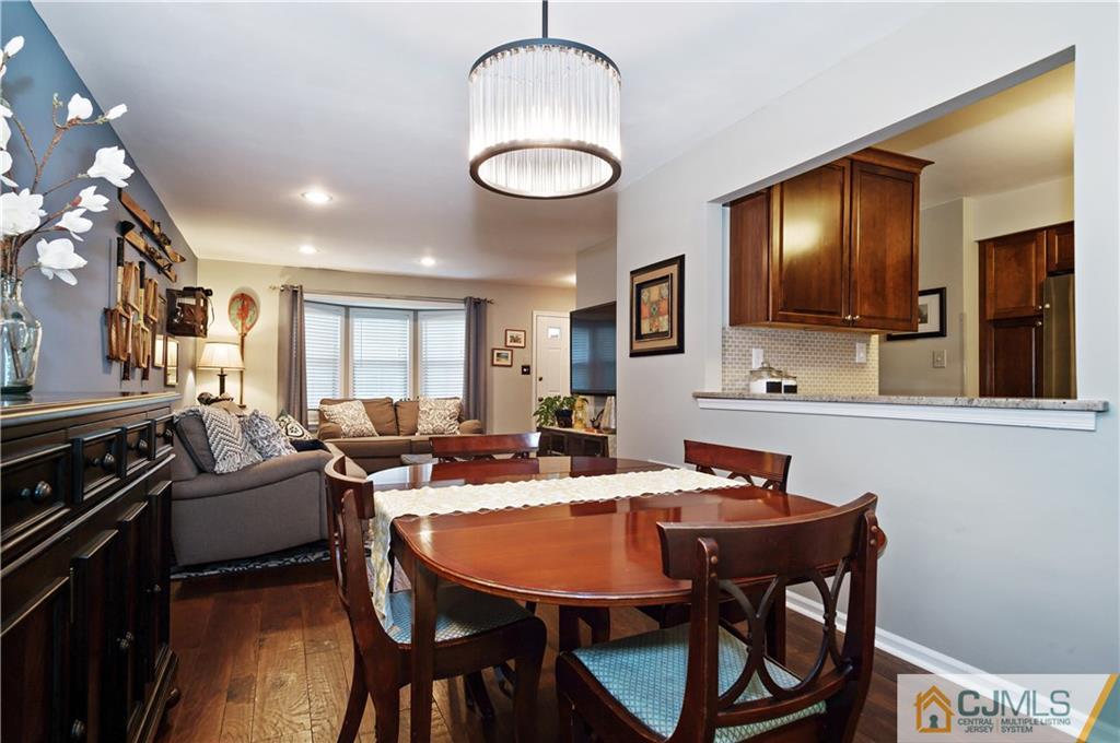 2406 Timber Oaks Road, Unit 2406 Edison, NJ 08820 - Photo 10 of 24 a view of a dining room with furniture window and wooden floor