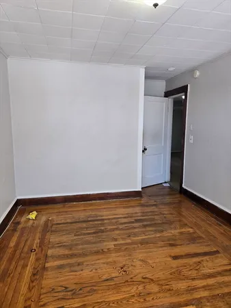 a view of an empty room and wooden floor