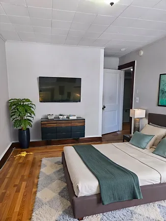 a bedroom with a bed and a television