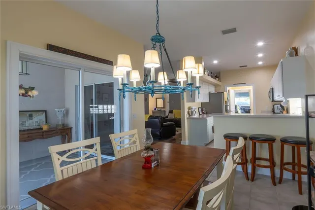 a kitchen with cabinets and chairs