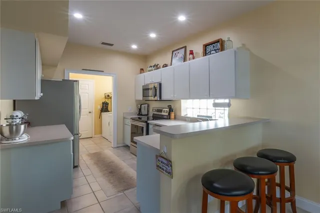 a kitchen that has a sink cabinets counter space and stainless steel appliances
