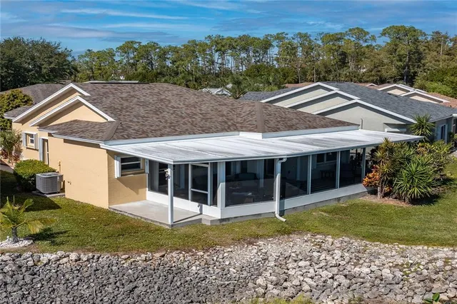 an aerial view of a house with swimming pool and ocean view