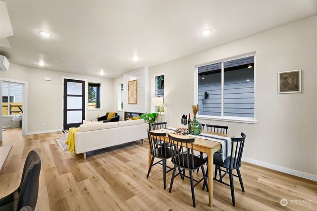 a living room with furniture a wooden floor and a bookshelf