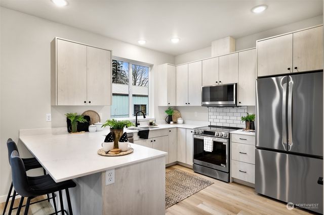 a kitchen with a stove a sink and a refrigerator