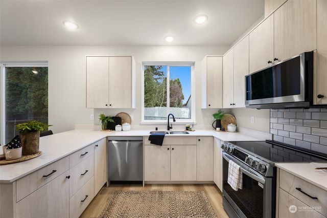 a kitchen with a sink stove and microwave
