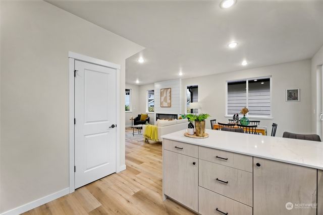 a view of a kitchen with a sink and wooden floor