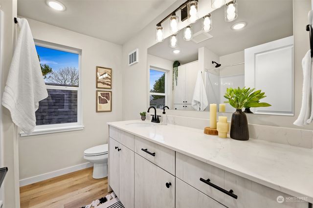 a bathroom with a sink a vanity and a mirror