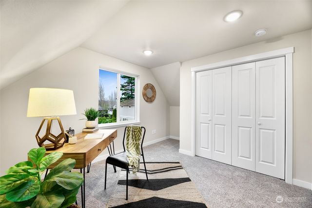 a living room with furniture a window and a potted plant