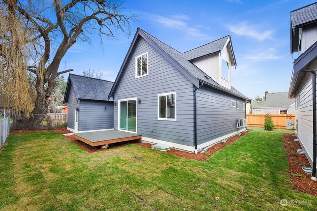 a view of a house with a yard and wooden deck