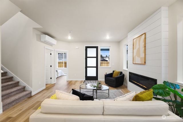 a living room with furniture and wooden floor