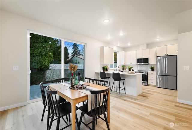 a view of a dining room with furniture window and wooden floor