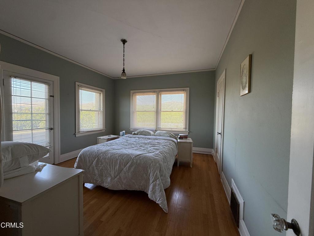 4645 Walnut Avenue Somis, CA 93066 - Photo 16 of 28 a spacious bedroom with a bed and a table in it