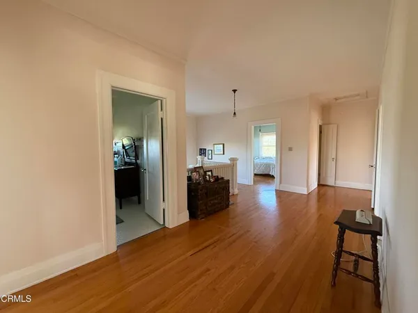 a view of staircase with lots of frames on wall and a window
