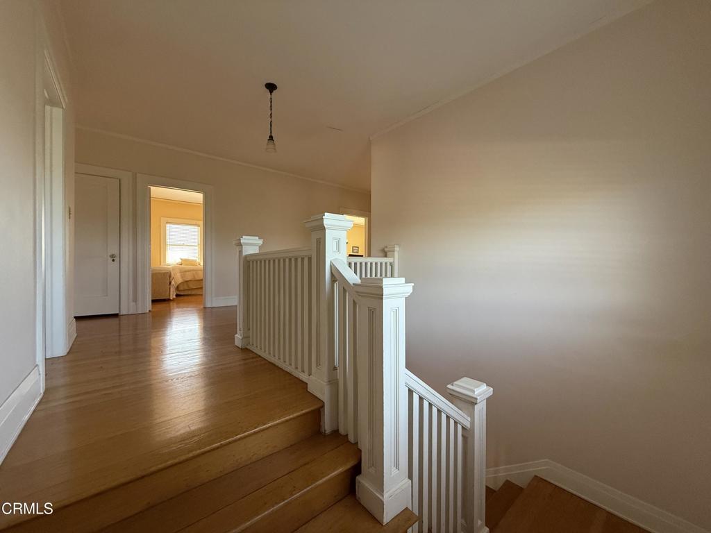 4645 Walnut Avenue Somis, CA 93066 - Photo 18 of 28 a view of a hallway with wooden floor and stairs