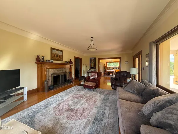 a front view of a house with yard and tree