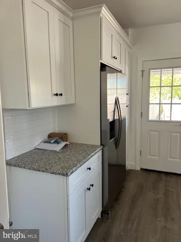 a kitchen with stainless steel appliances granite countertop a sink a stove and a refrigerator