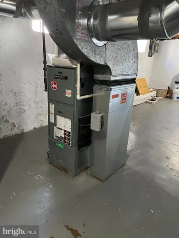 a room with water heater and a wooden floors