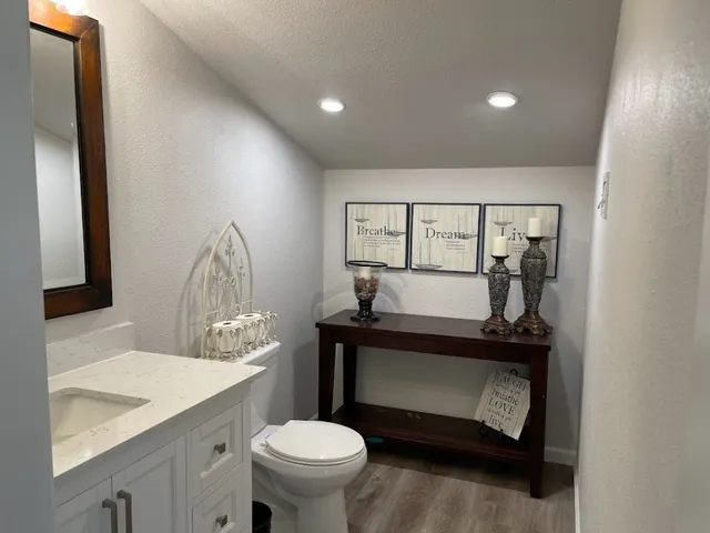 a bathroom with a sink toilet and mirror