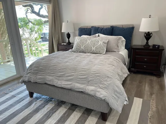 a bed sitting in a bedroom next to a window