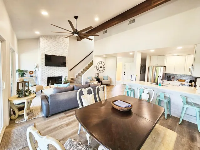 a living room with fireplace furniture and a wooden floor