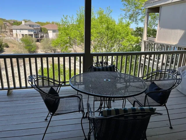 a view of a balcony with chairs