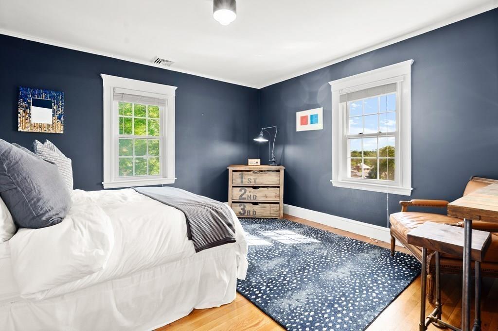 24 Cedarwood Road Boston, MA 02130 - Photo 12 of 18 a bedroom with a bed and wooden floor