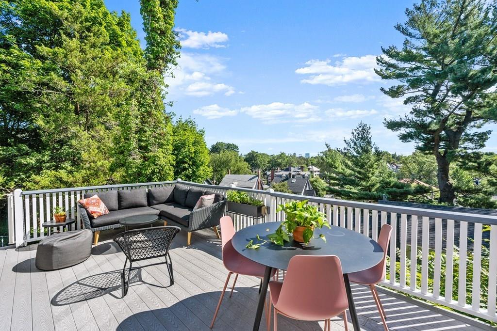 24 Cedarwood Road Boston, MA 02130 - Photo 16 of 18 a roof deck with table and chairs and wooden floor