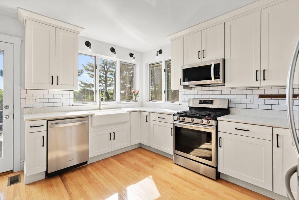 24 Cedarwood Road Boston, MA 02130 - Photo 5 of 18 a kitchen with stainless steel appliances granite countertop a stove a sink and a microwave