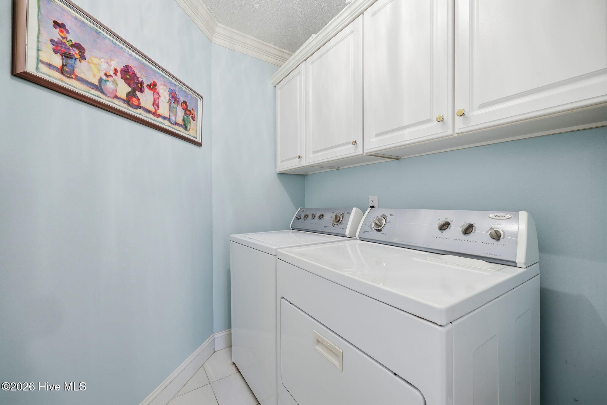 4076 Mobleys Bridge Road Grimesland, NC 27837 - Photo 38 of 66 laudry room, tiled floro and storage cabinets