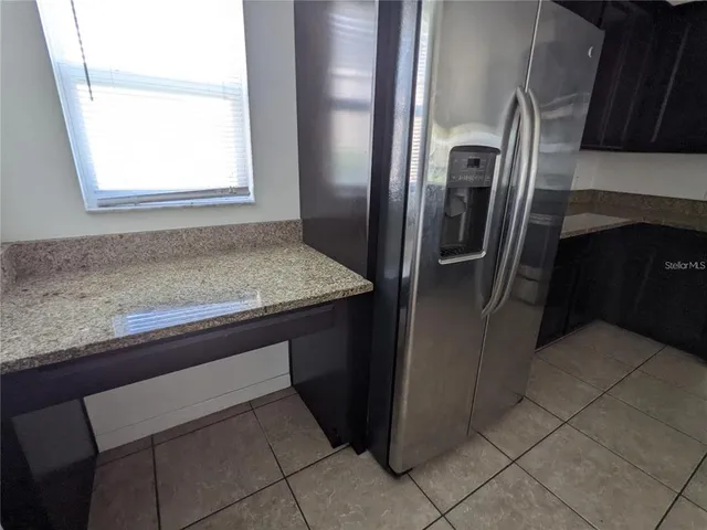 a kitchen with a refrigerator and a sink