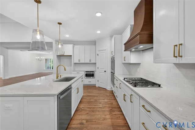 a kitchen with stainless steel appliances a sink stove and cabinets
