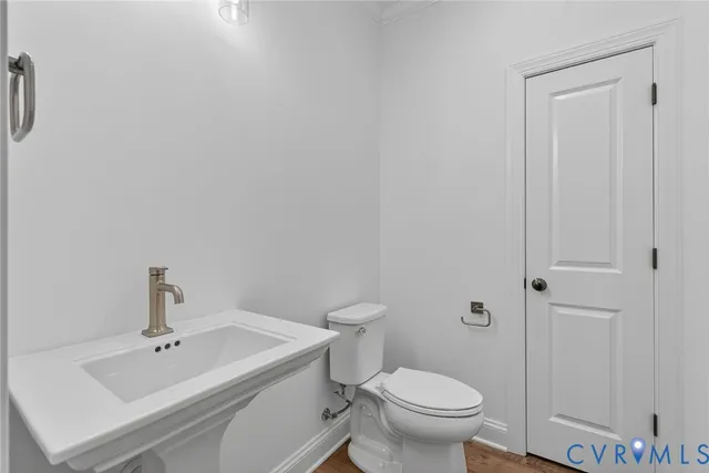 a white toilet sitting next to a bathroom sink