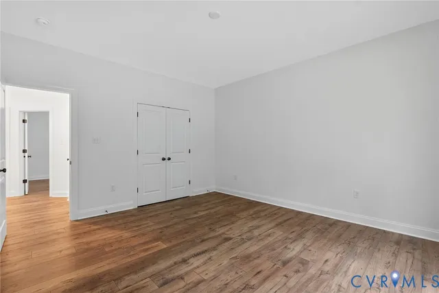 a view of room with wooden floor