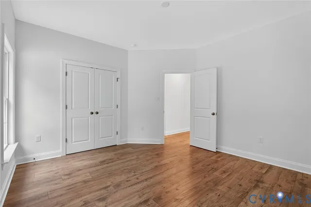 a view of an empty room and wooden floor