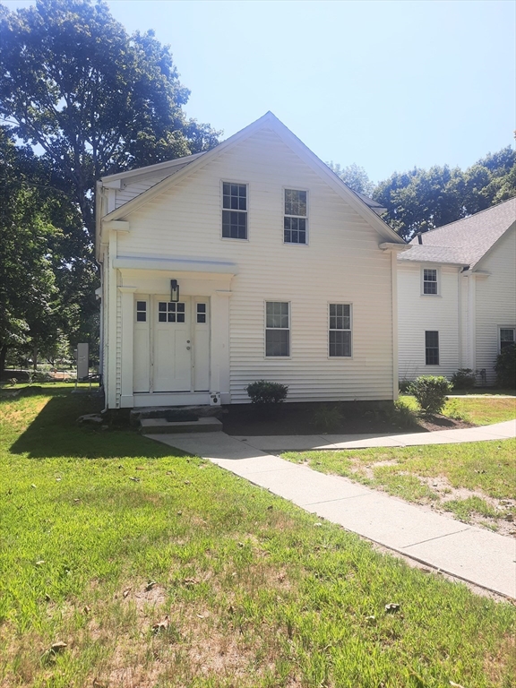 a backyard of a house with table and chairs