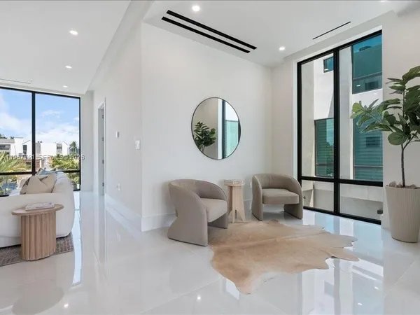 a living room with furniture and a floor to ceiling window
