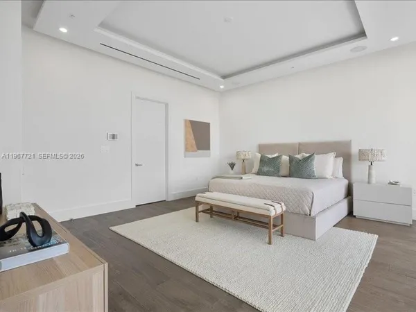 a spacious bedroom with a large bed and a large window